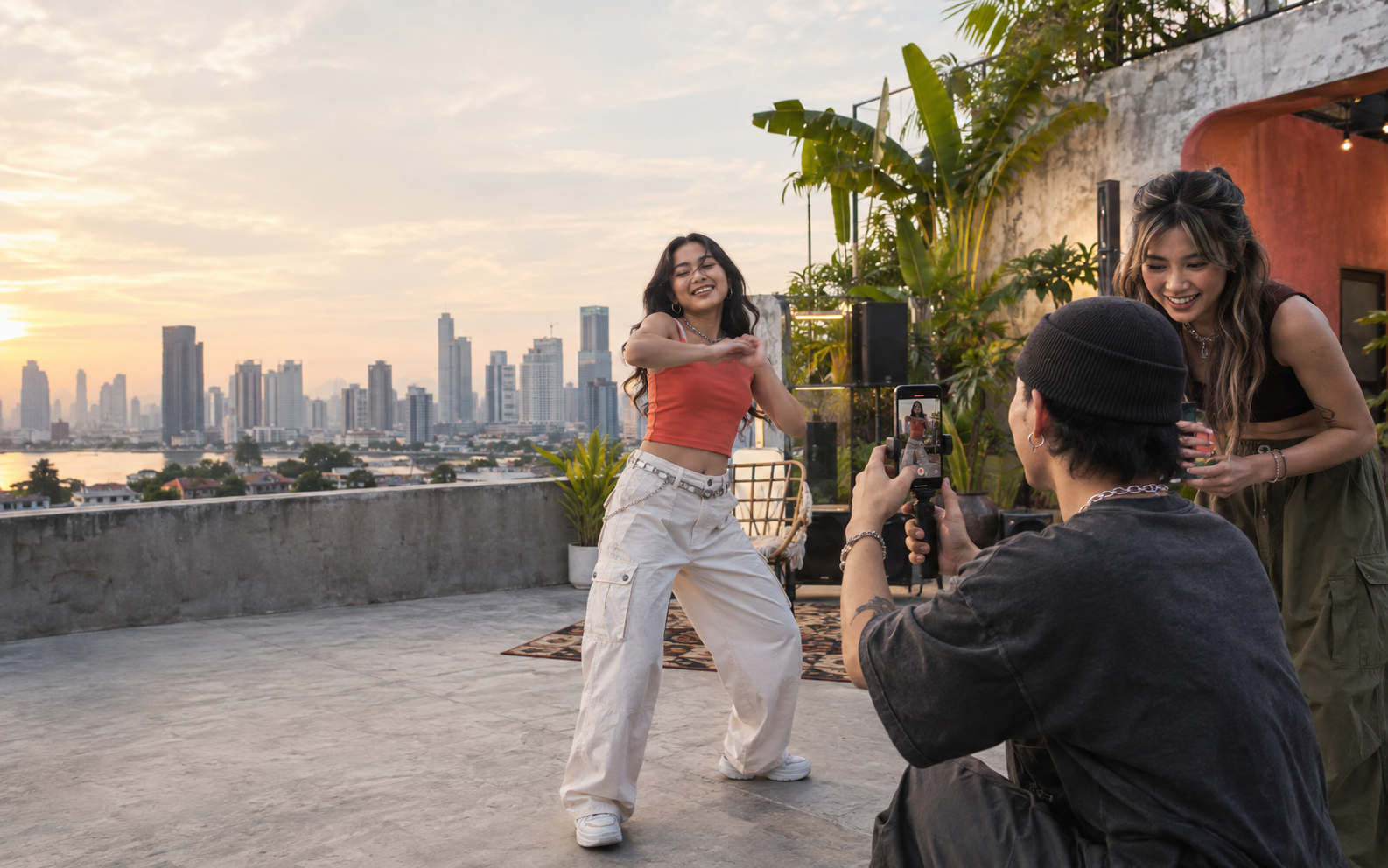 Three Southeast Asian creators filming a music video together on a rooftop
